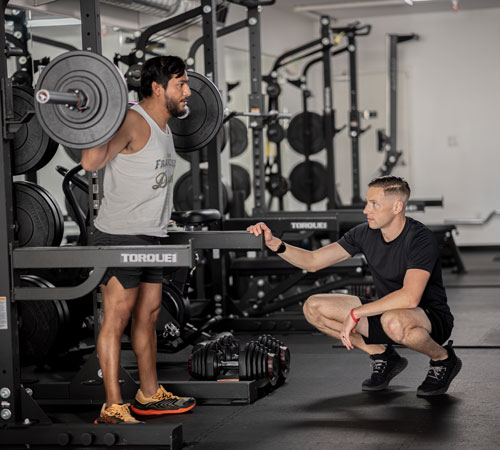Ross Dempsey coaching a squat at The Yard, San Francisco