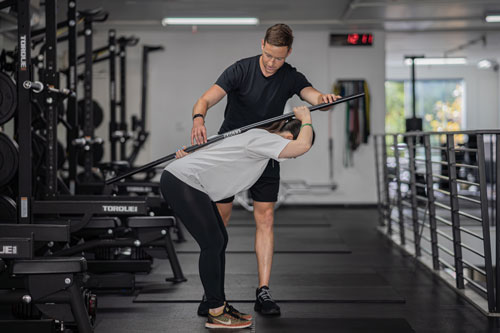 Hip hinge coaching with a barbell at The Yard